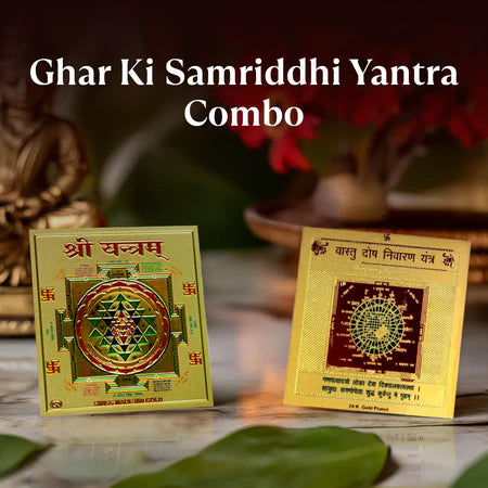 Ghar Ki Samriddhi Yantra Combo with golden Sri Yantra and Vastu Dosh Nivaran Yantra placed on marble surface with blurred decorative background
