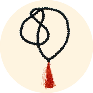 Black Karungali prayer beads necklace with red tassel on orange background