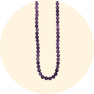 Purple beaded necklace displayed on a round yellow background, showcasing elegant jewelry design