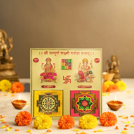 Golden spiritual board with Lakshmi and Ganesha idols, yantras, marigold flowers, and lit diyas for worship