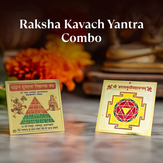 Raksha Kavach Yantra Combo featuring two decorative golden spiritual amulets on marble surface with orange marigold background