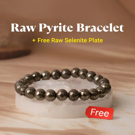 Raw pyrite bead bracelet displayed on a free raw selenite plate with a neutral brown background